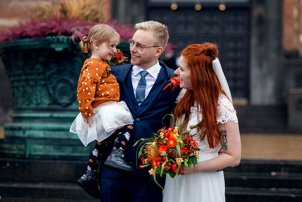 bride, groom and daughter at Copenhagen City Hall, photos by Natalia Cury wedding photographer