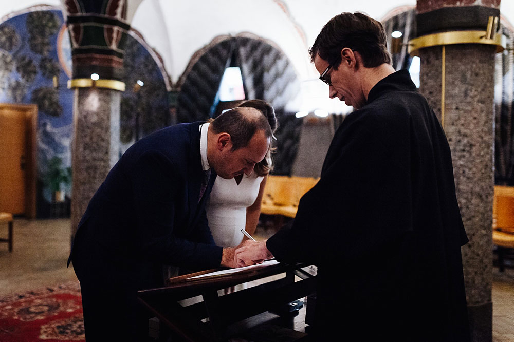 groom signing wedding papers at Copenhagen City Hall