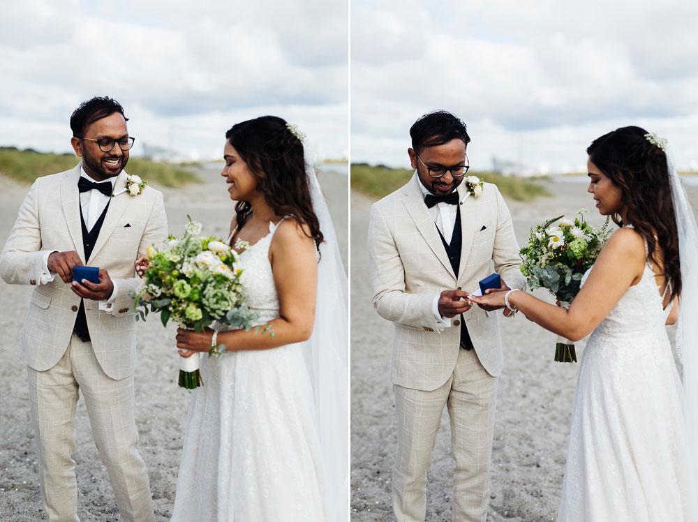 bride and groom exchanging rings at their civil wedding ceremony at Amager strand in Copenhagen