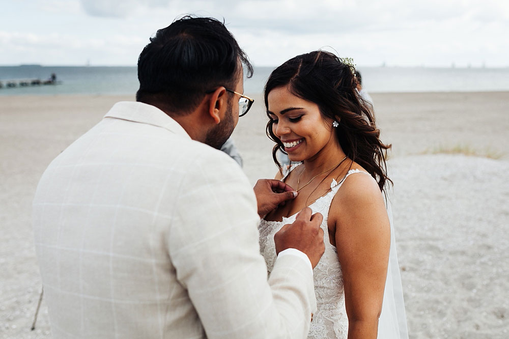 groom giving a necklace to the bride