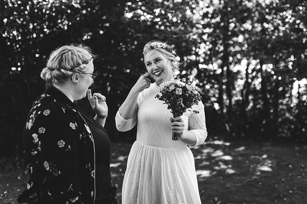bride and guest talking at open air wedding reception in Stevns Klint
