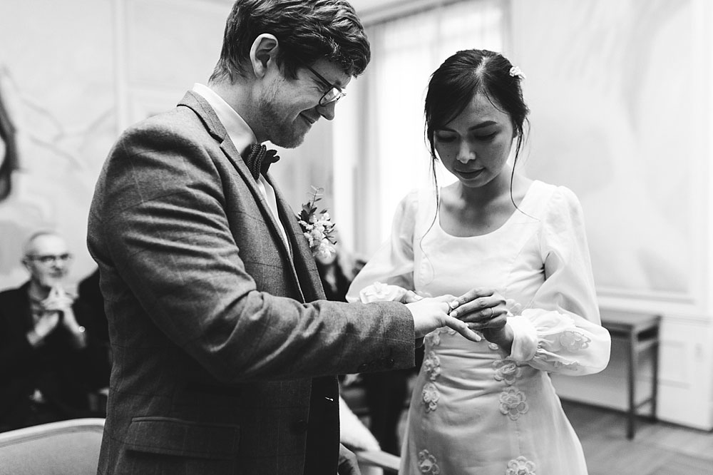 Civil wedding ceremony at Frederiksberg City Hall. Bride and groom exchanging wedding rings.