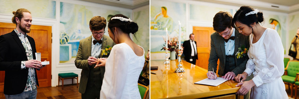 Civil wedding ceremony at Frederiksberg City Hall. Bride and groom exchanging wedding rings.