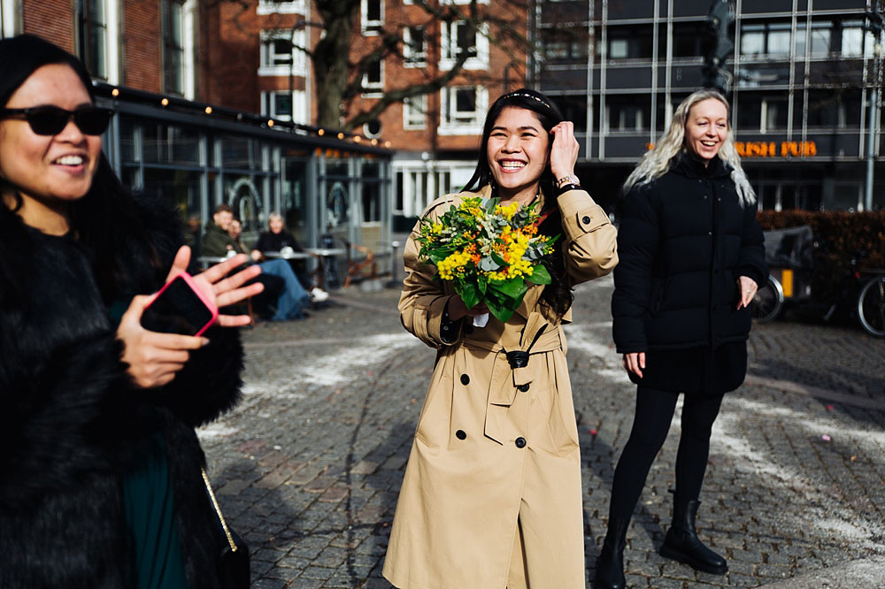 bride throwing the bouquet at Frederksberg Town Hall