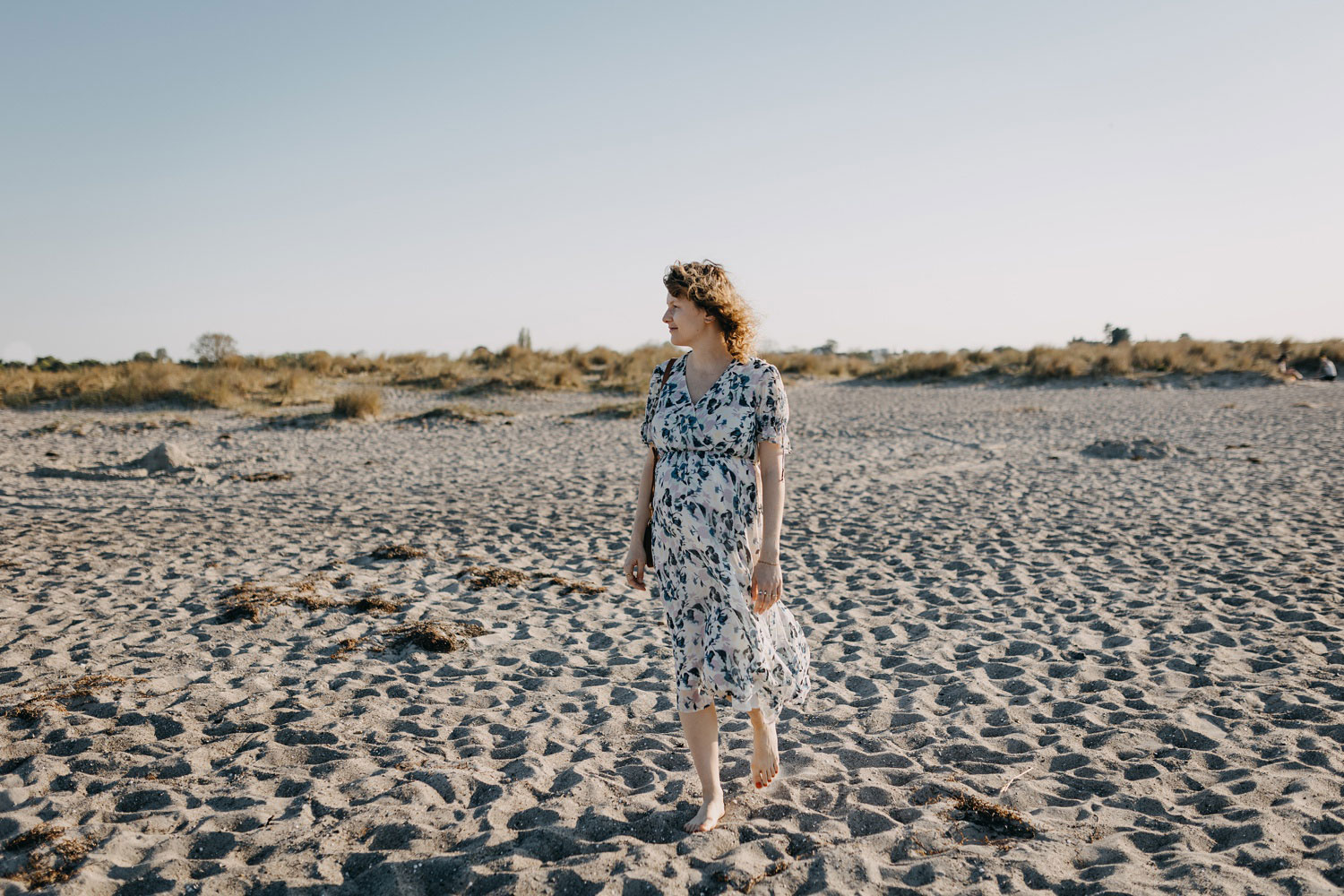 Candid moments of an expectant mother cherishing her pregnancy at a Copenhagen beach
