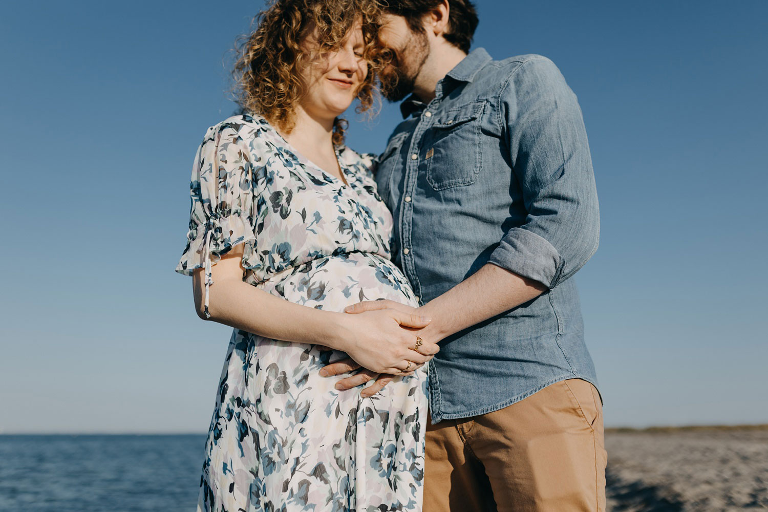 Gorgeous expecting mother enjoying the sandy shores of Copenhagen