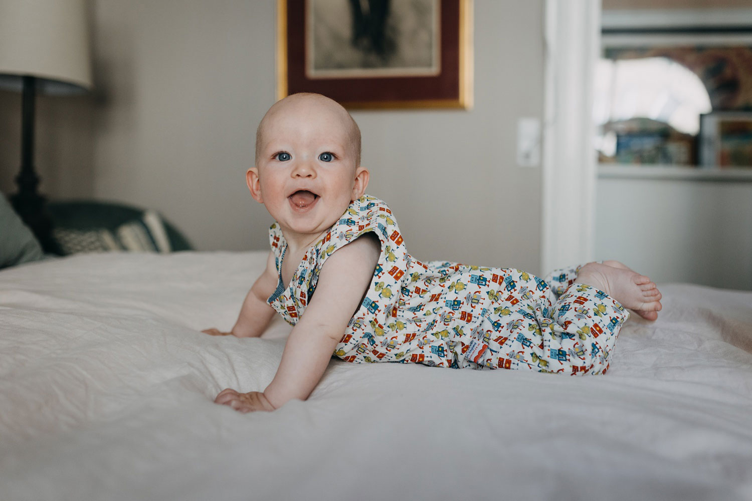 Sweet 6-month-old baby giggling during a playful photoshoot at their Copenhagen home