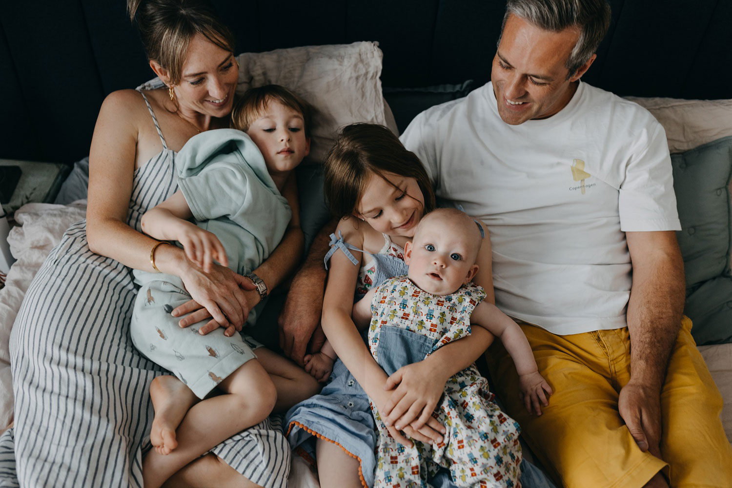 Loving parents and children embracing at home in Østerbro, Copenhagen. 