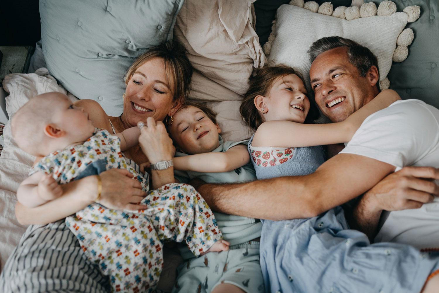 Copenhagen family photographer captures heartwarming moments of a family cuddling at home