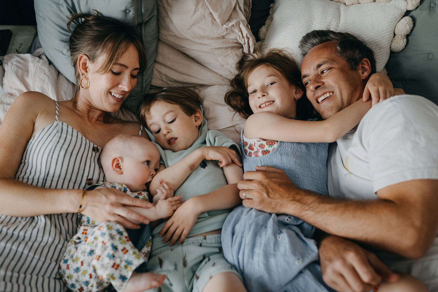 Copenhagen family photographer captures heartwarming moments of a family cuddling at home