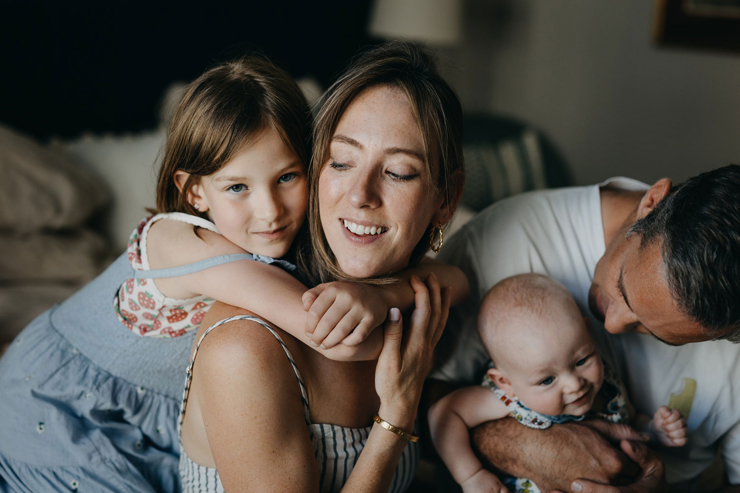 mother and daughter hugging during a family photo session at home in Copenhagen