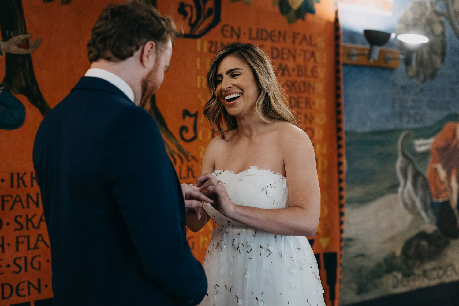 bride and groom exchanging rings during a civil wedding ceremony at Copenhagen city Hall