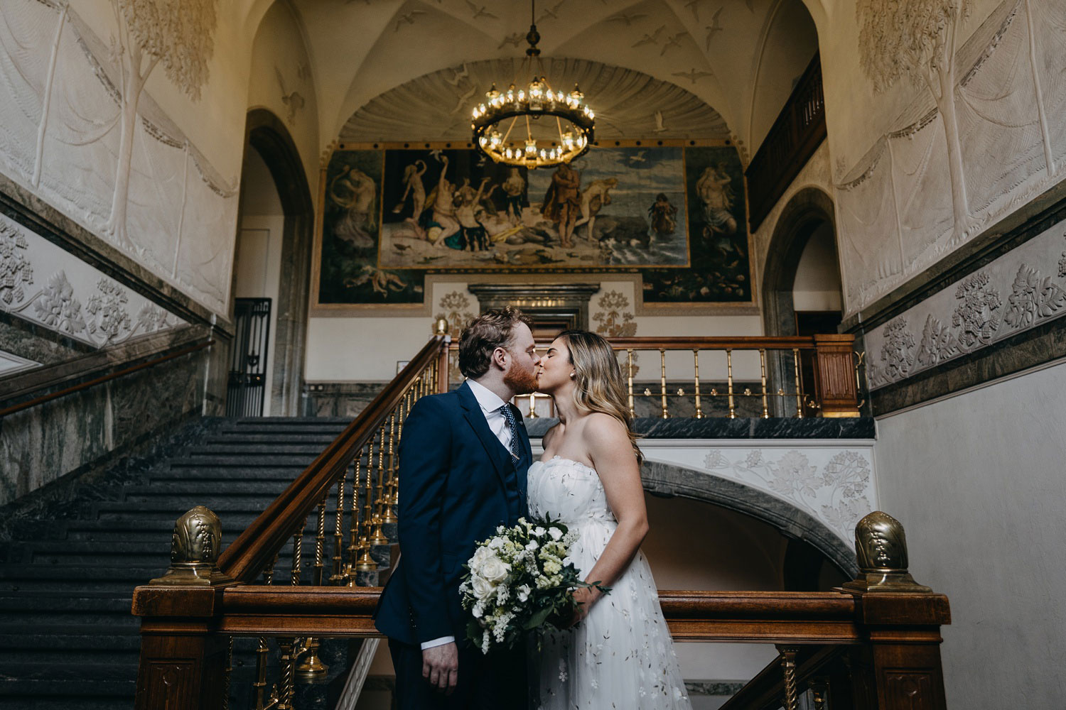 bride and groom kissing at scenic location in Copenhagen - Copenhagen city hall weddings