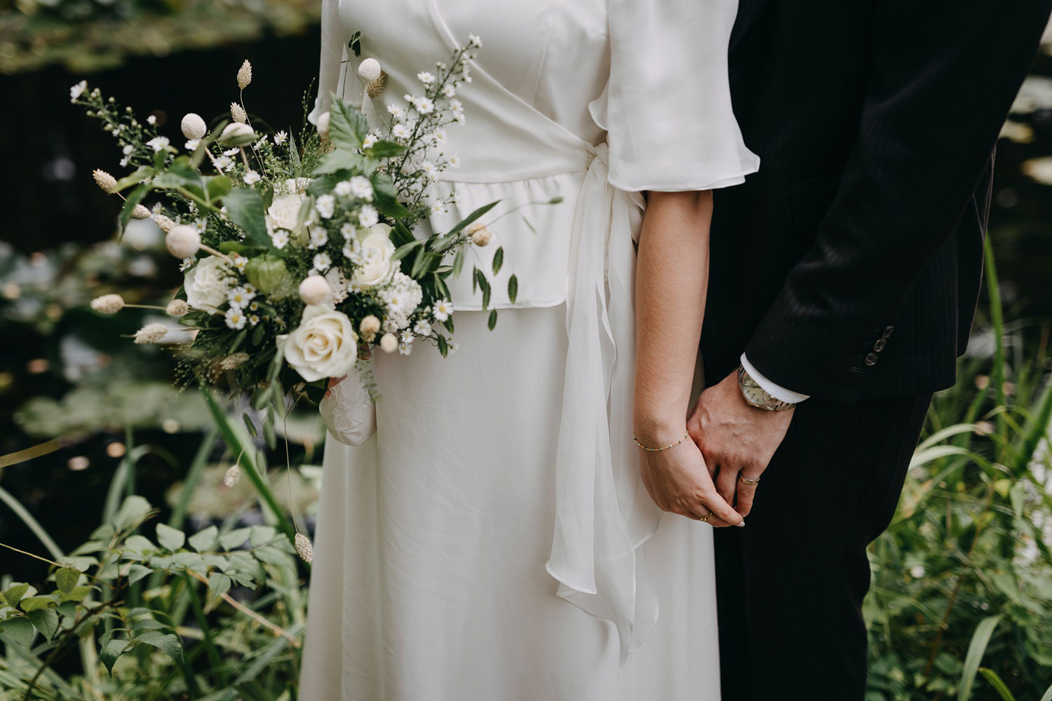 beautiful bridal bouquet held delicately by the bride, featuring white flowers