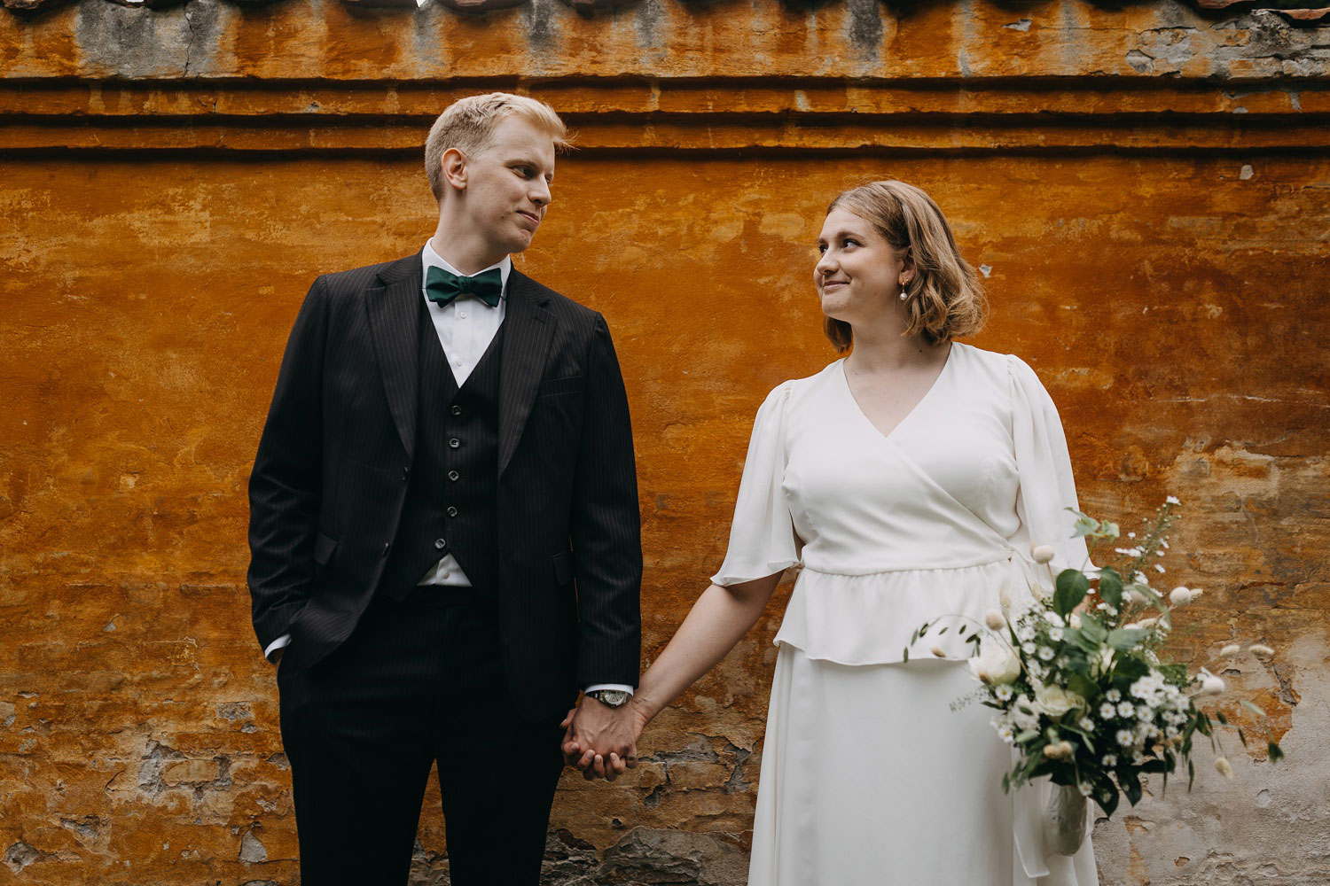 Newly married couple sharing a loving glance in the idyllic surroundings of Frederiksberg Have, Copenhagen