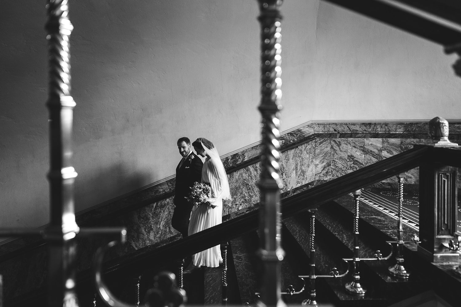 bride and groom going down the stairs at Copenhagen City Hall