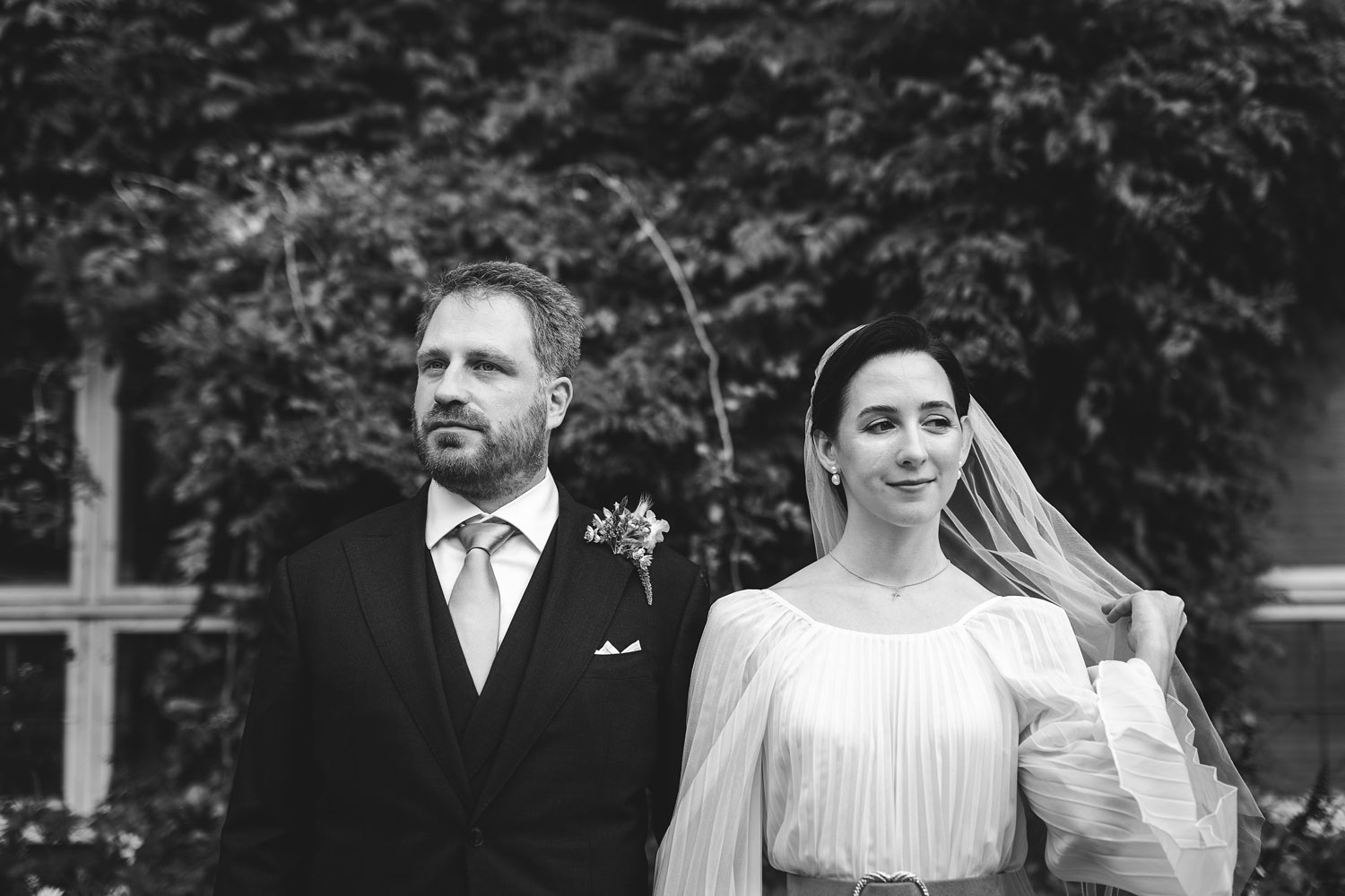 bride and groom outside Copenhagen city hall posing for wedding portraits