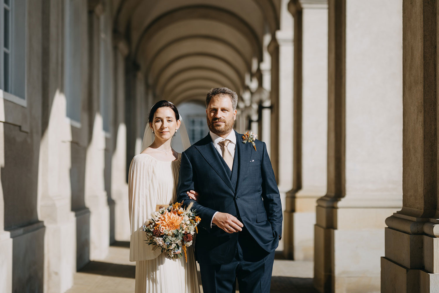 bride and groom outside Copebride and groom posing for wedding portraits at Christiansborg Slot in Copenhagen