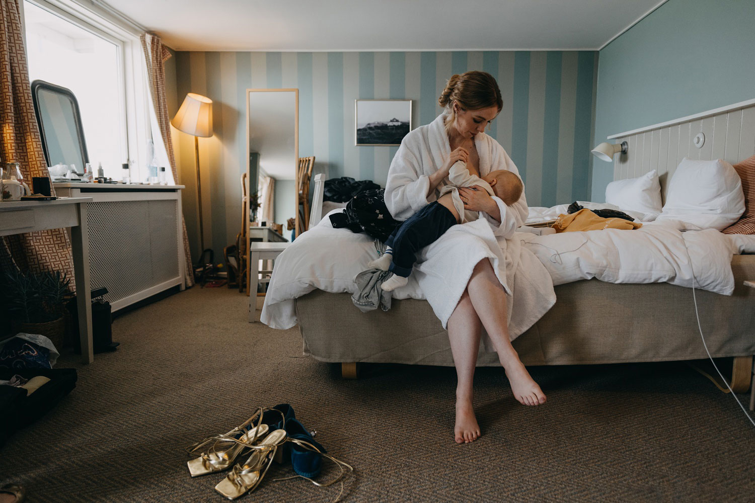 bride breastfeeding her baby before the wedding ceremony at Helenekilde Badehotel