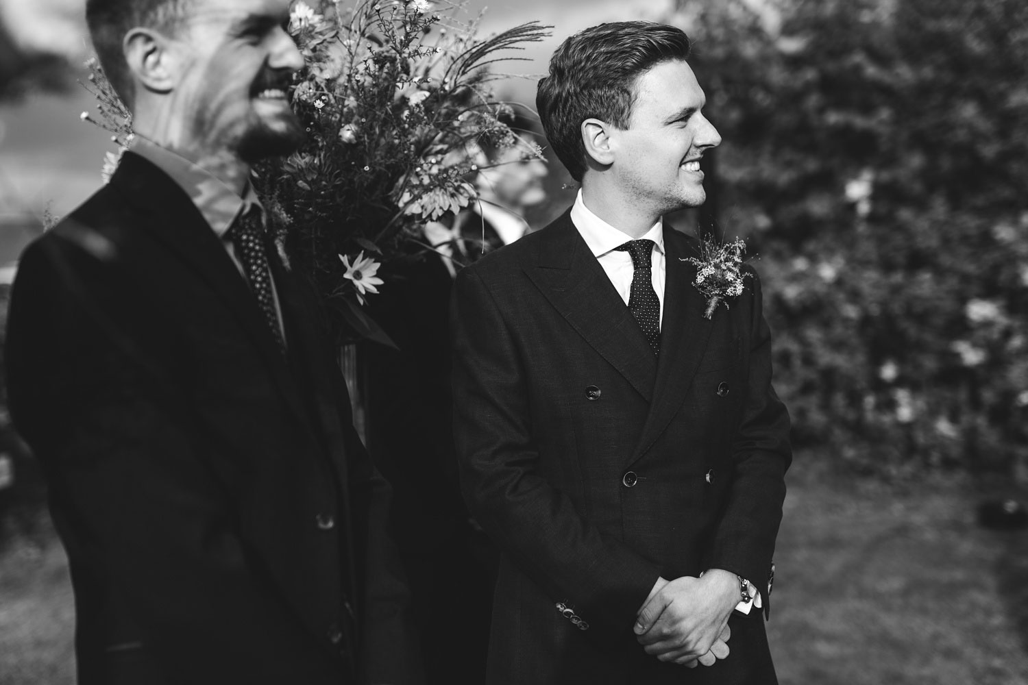 groom watching bride walk down the aisle