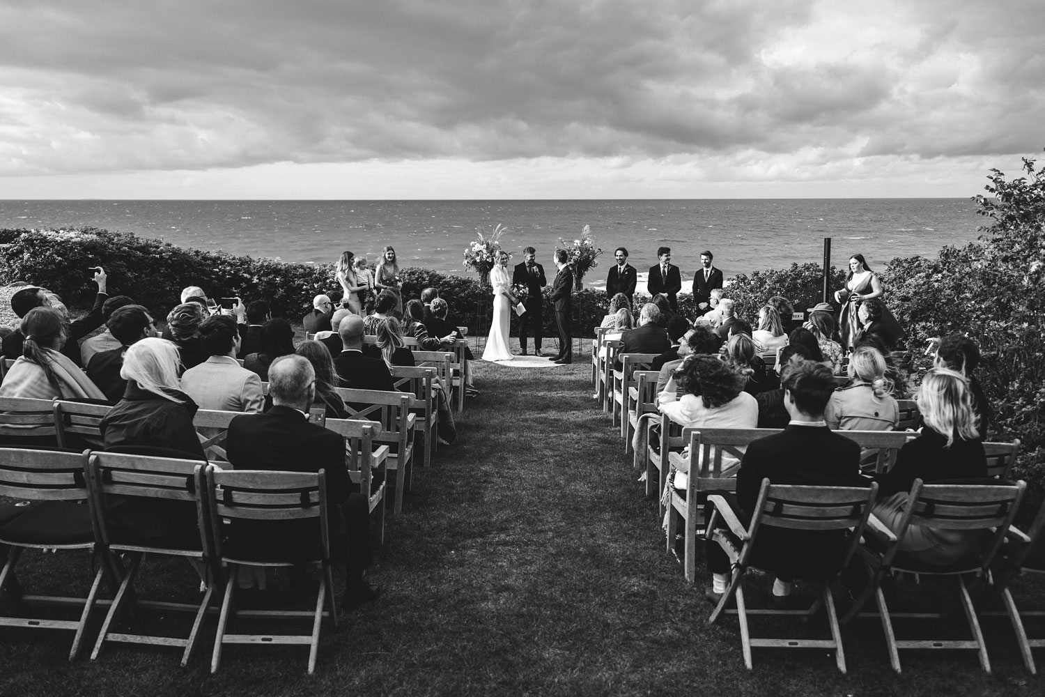 Seaside serenity at the open-air ceremony at Helenekilde Hotel, with the vast sea as a stunning backdrop
