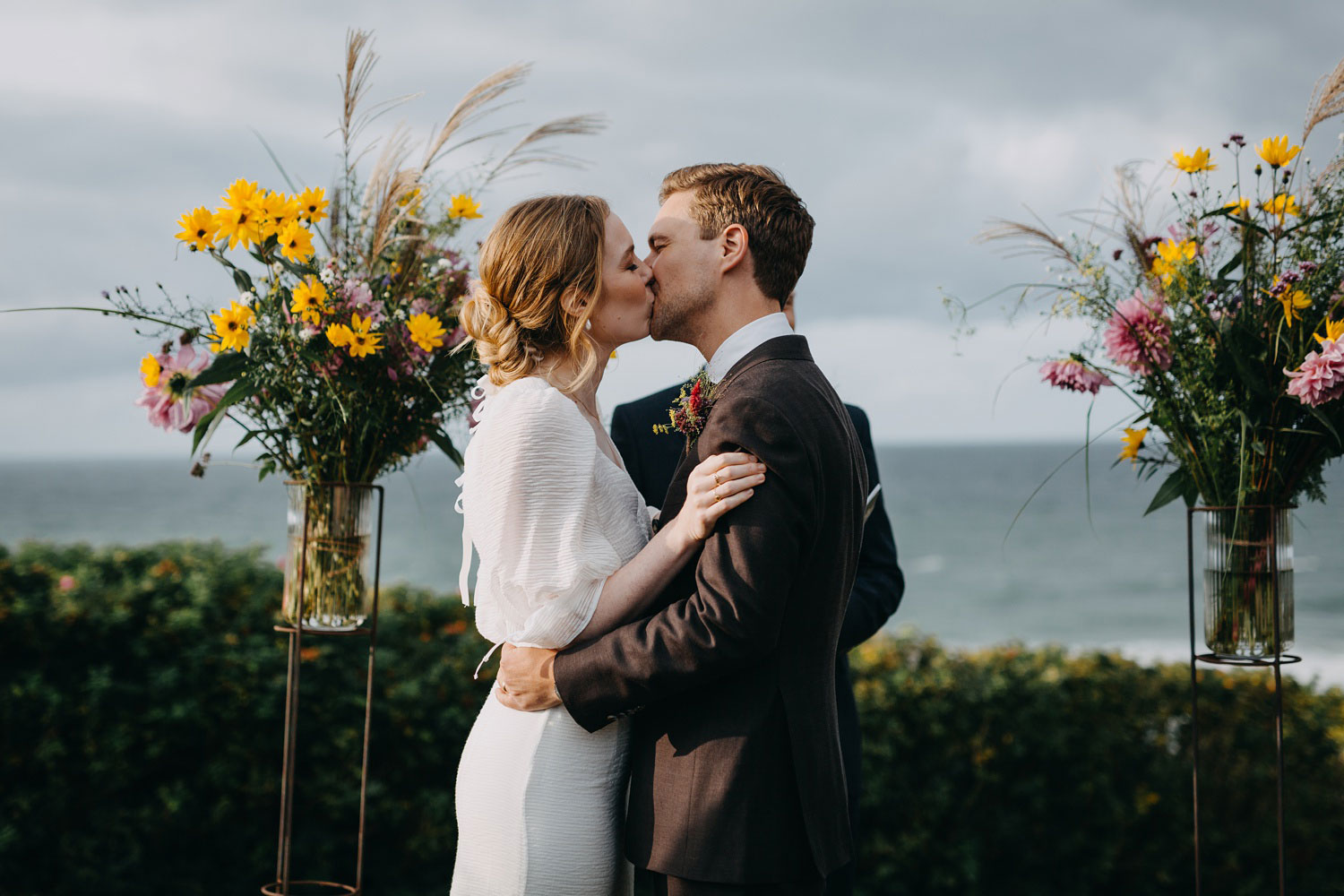 Sealing the vows with a kiss at Helenekilde Badehotel, Tisvildeleje, framed by the beauty of nature and love