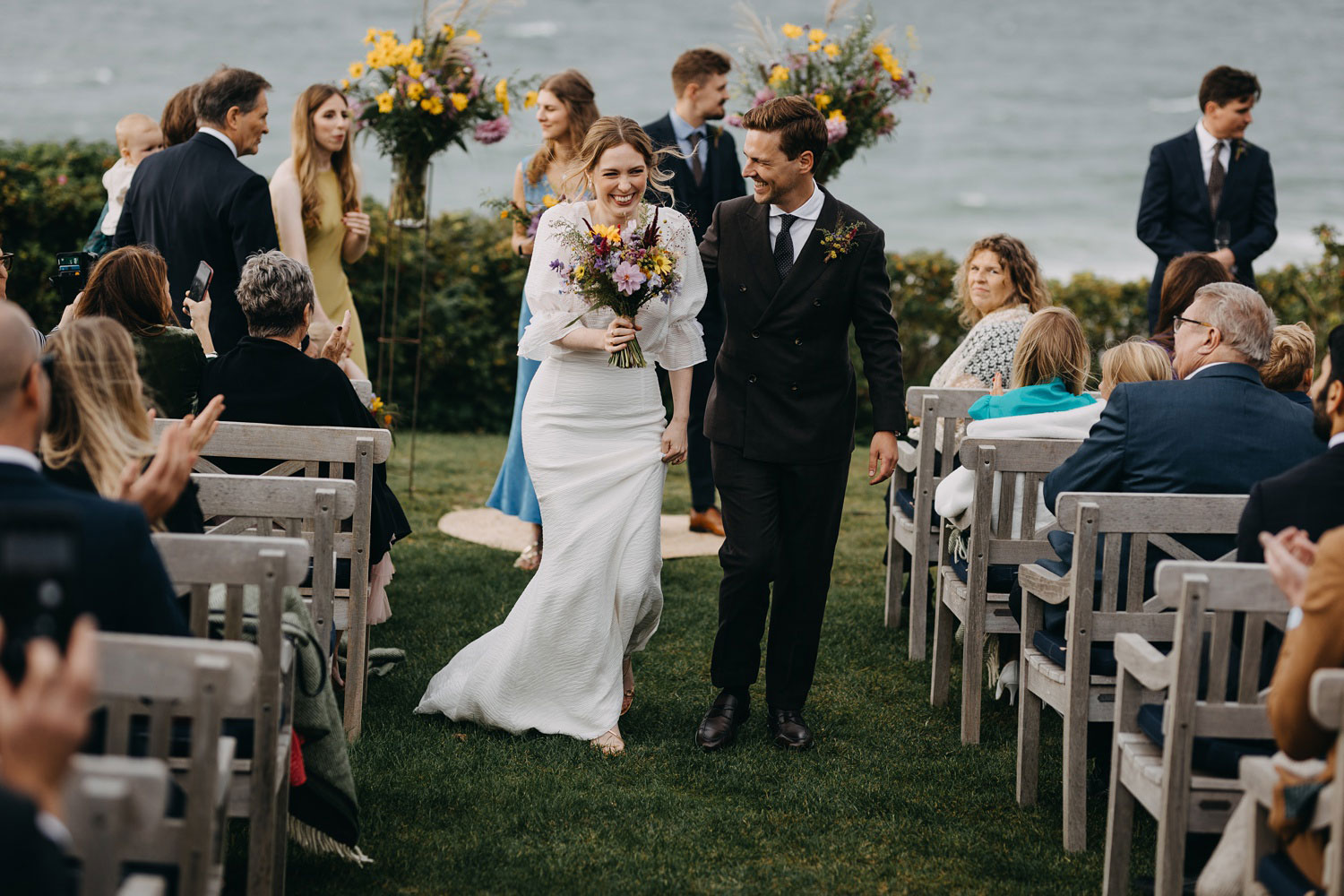 the newly pronounced couple leaves the wedding ceremony venue at Helenekilde Hotel