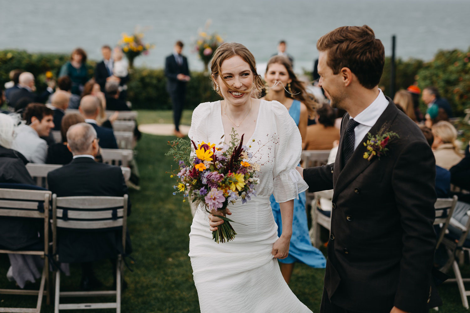 Radiant smiles as the bride and groom walk down the aisle, officially married