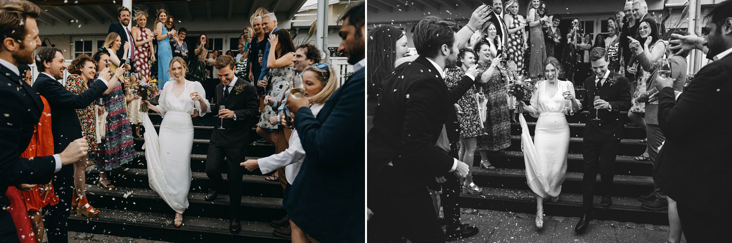 the couple walks down the stairs, embraced by the celebratory rain of rice from friends and family at Helenekilde