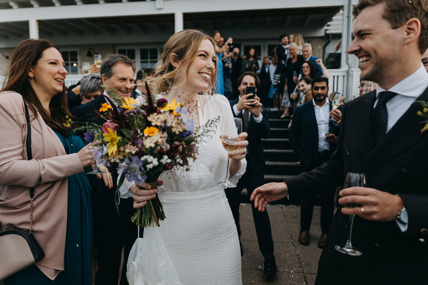 bride and groom  surrounded by the festive toss of rice