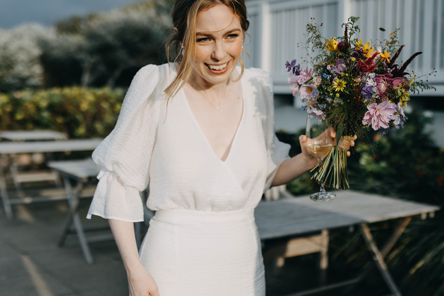 beautiful and elegant bride holding her wild flowers bouquet