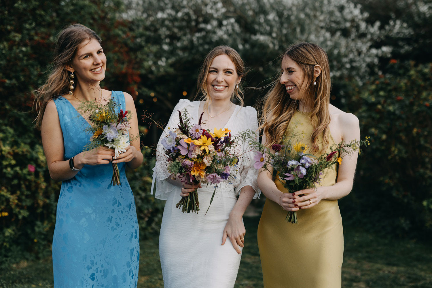 bride and bridesmaids holding their flowers at Helenekilde Badehotel in Tisvildeleje