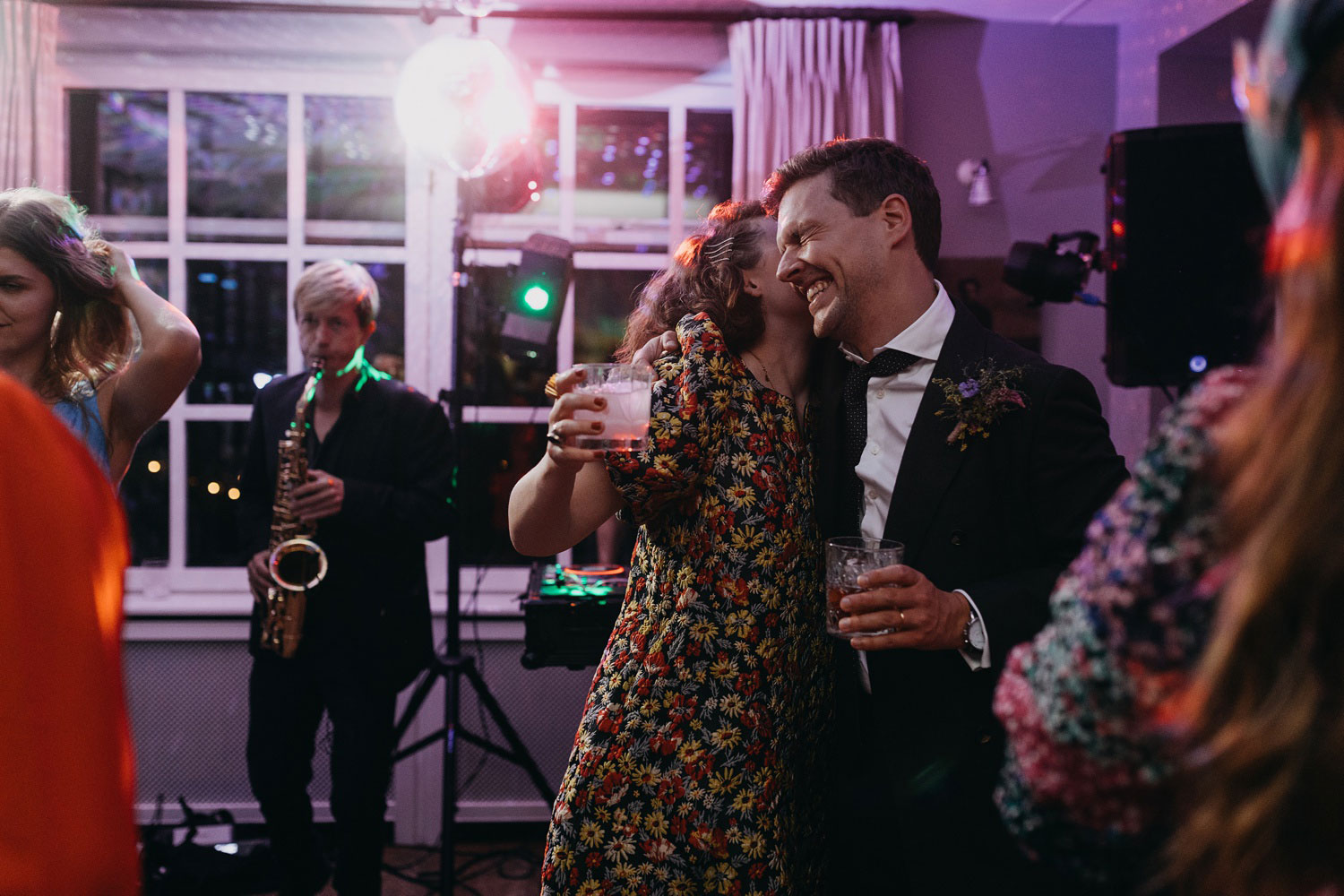 Candid laughter and shared memories among friends during the lively party at Helenekilde Badehotel, Tisvildeleje