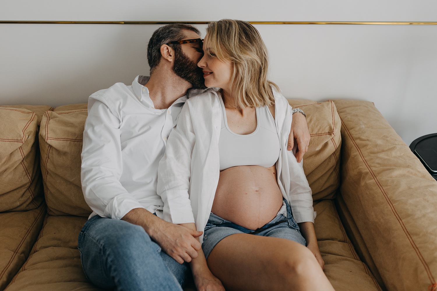 maternity photo session: Expectant couple sharing a tender moment at home