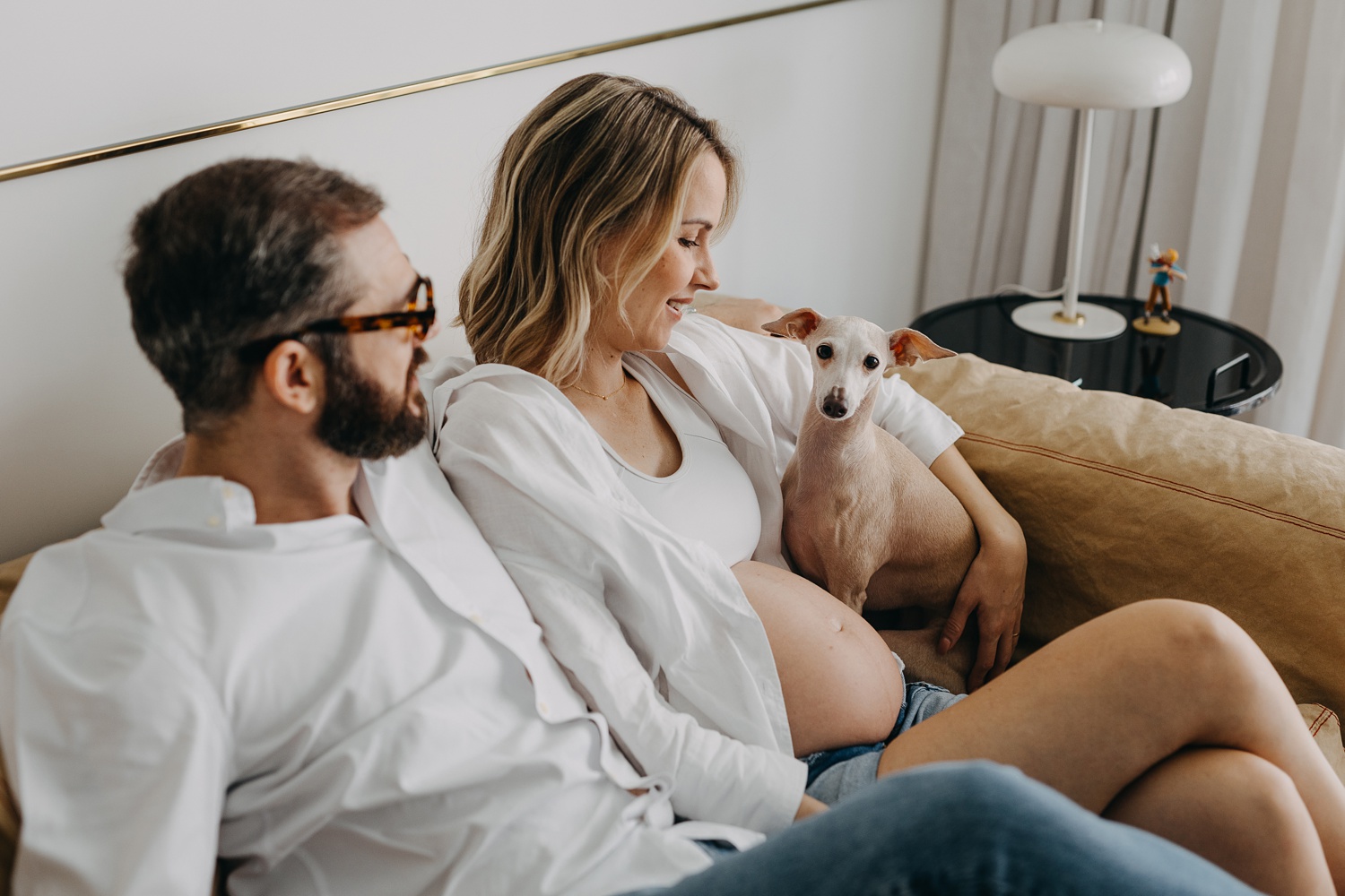 Joyful moments of pregnancy captured at home, accompanied by the playful spirit of Italian Greyhounds