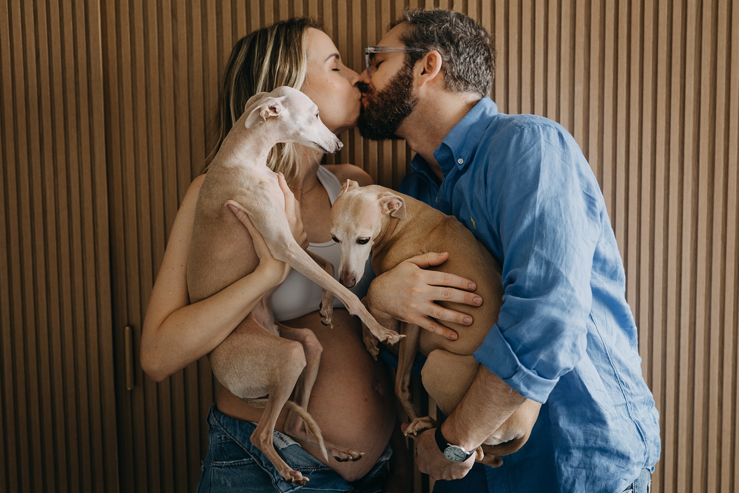 In-home maternity session filled with love, laughter, and the delightful presence of two Italian Greyhounds