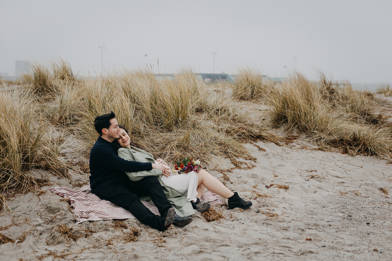 Maternity portrait session amidst scenic beauty of Amager Strand