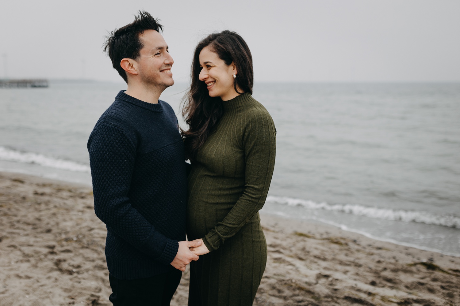 Maternity photography session featuring serene moments by the water