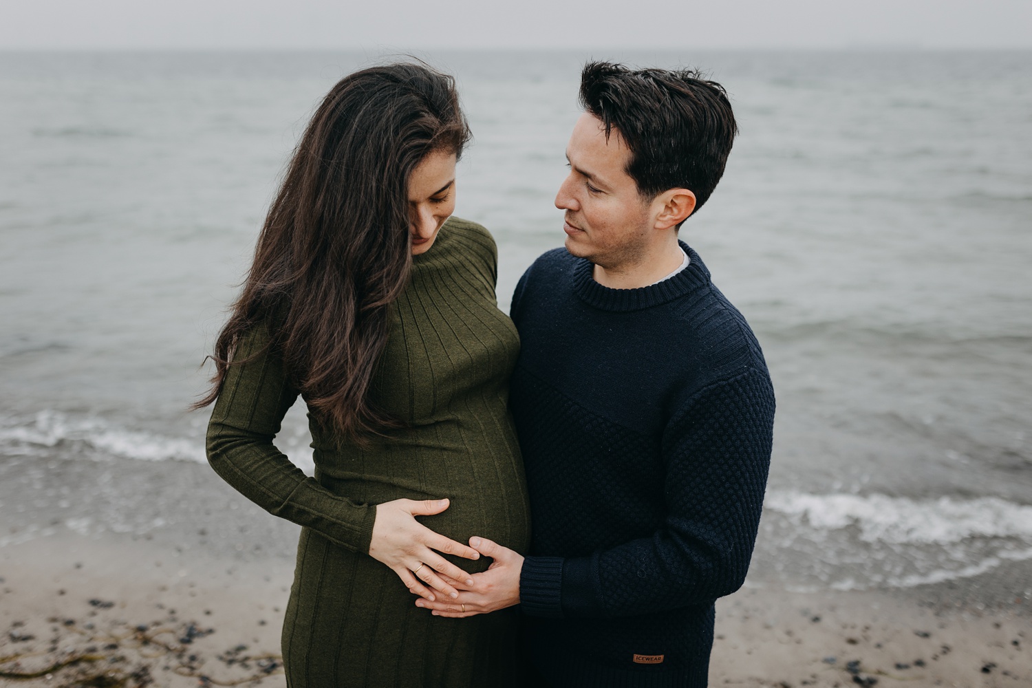 Maternity photography session featuring serene moments by the water