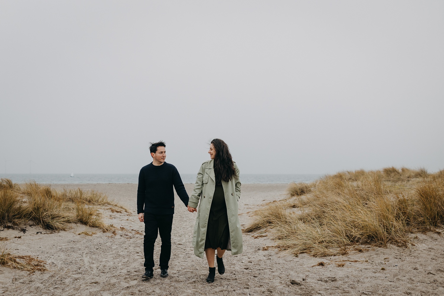 Maternity portrait session amidst scenic beauty of Amager Strand