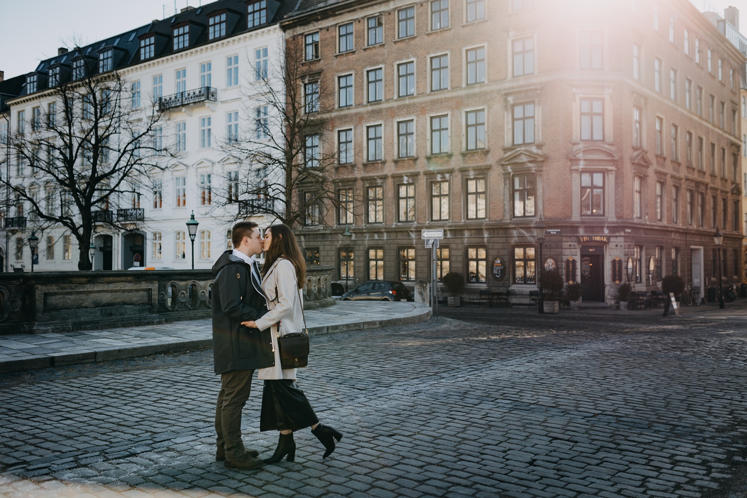 Intimate surprise engagement amidst cobblestone streets of Copenhagen
