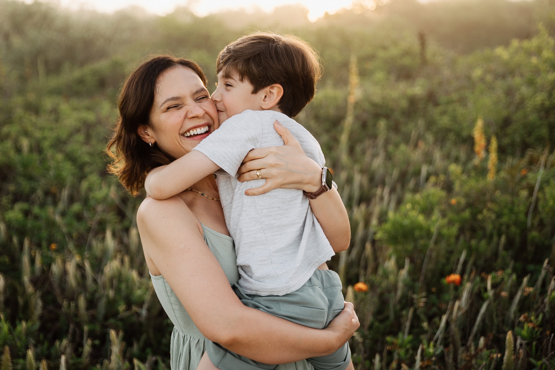 Mother and child hugging during beach family photo session in Brazil