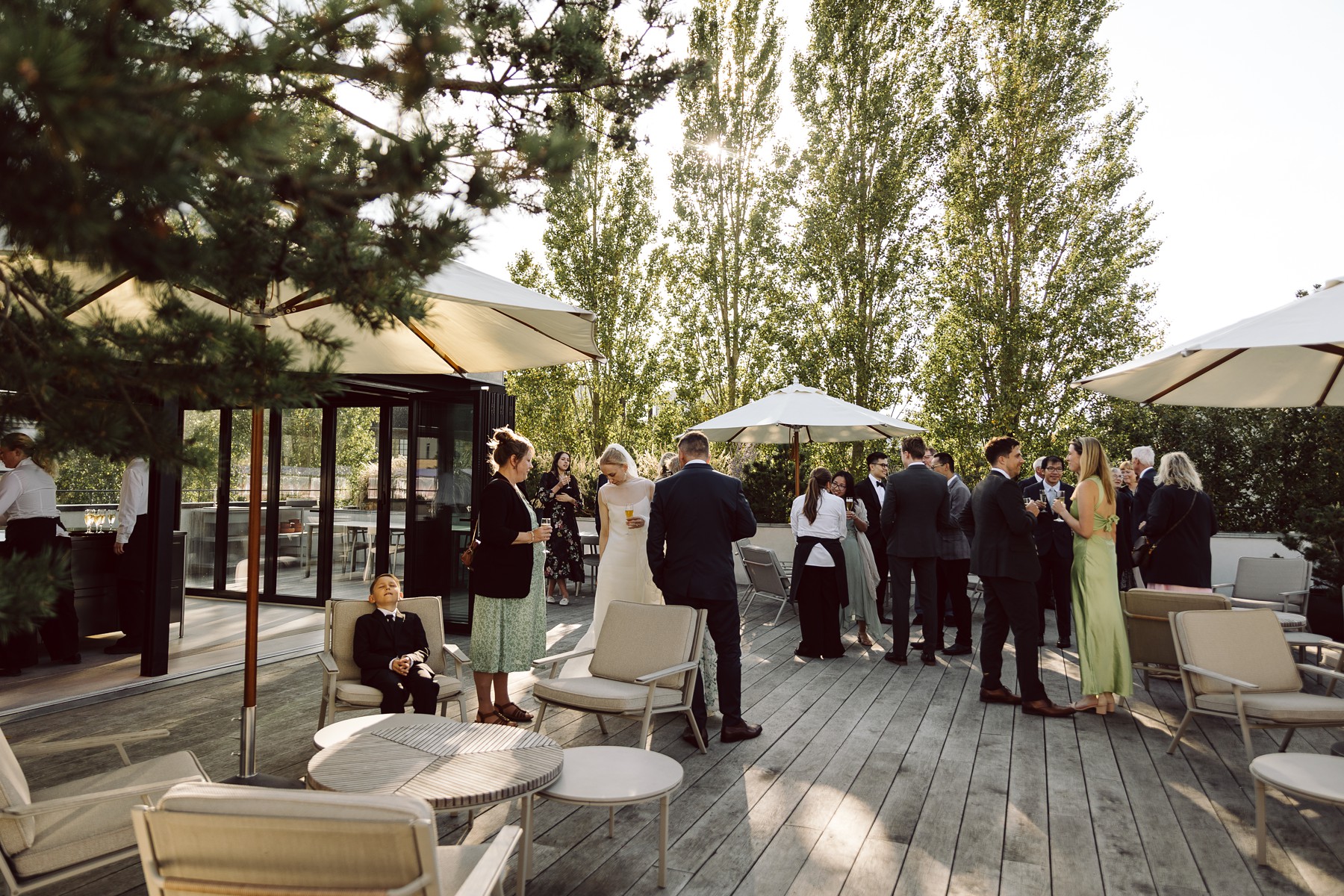 Wedding guests mingling and enjoying drinks at a summer reception at Mogens Dahl Koncertsal