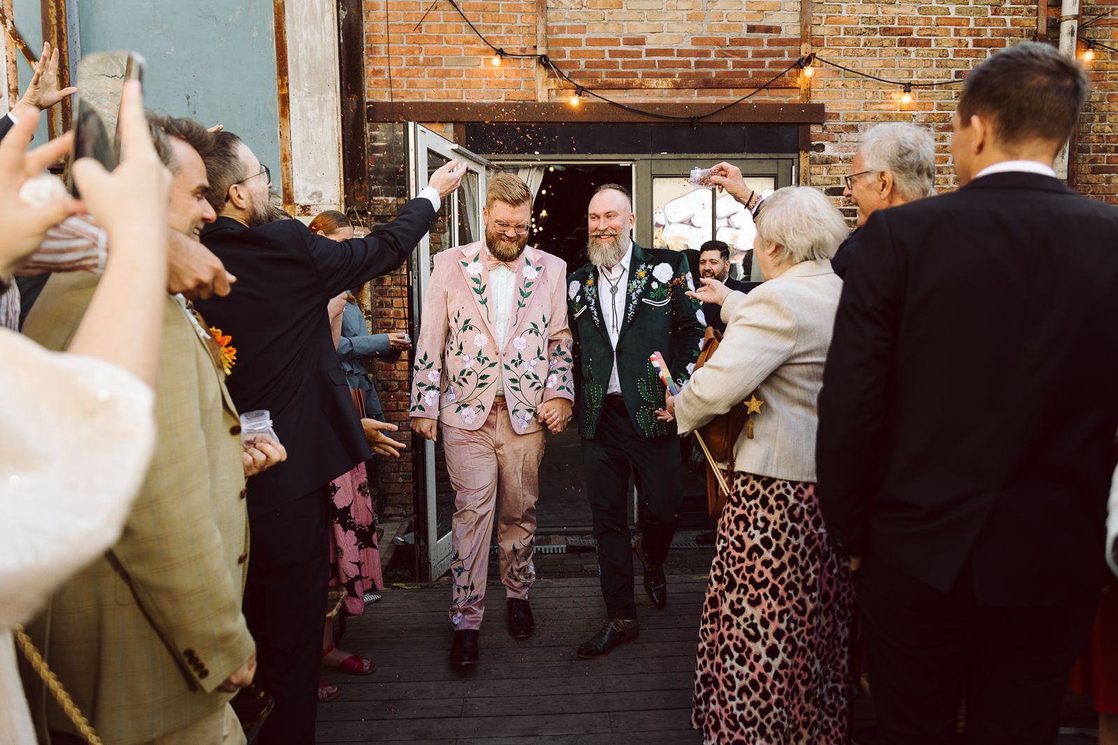 guests celebrating same-sex couple during a wedding ceremony at AFKROG Reffen in Copenhagen.