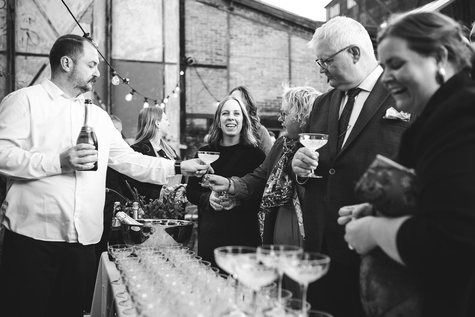 Friends celebrating and chatting during cocktail hour at a Reffen Copenhagen wedding