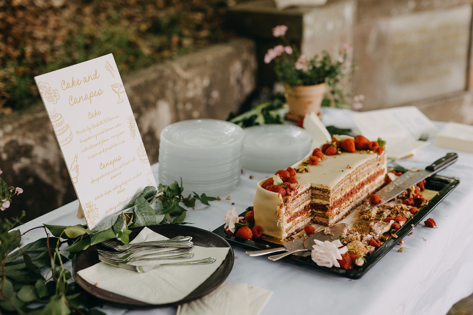 Wedding cake displayed at an outdoor reception in Copenhagen