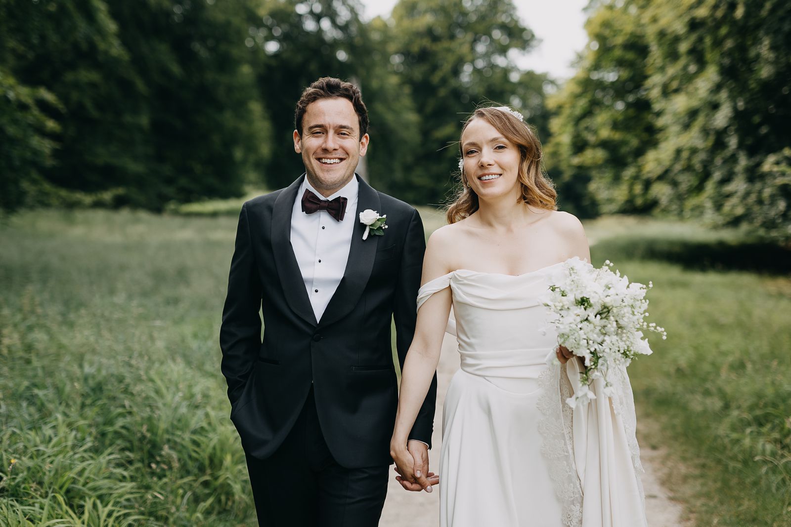 Bride and groom walking through nature after their ceremony in Denmark